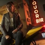 GTA 6 co-protagonist, Lucia Caminos, looks towards the camera on a yellow sports bike