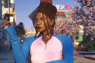 An image of a black woman with dreadlocks and a pink and blue zip up top standing in front of cherry blossoms and a building with a Japanese sign