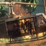 Hell Let Loose Vietnam post-launch update roadmap kicks off with two highly requested weapons and Hueys with radios - A group of soldiers prepares to disembark from a helicopter into the jungle.