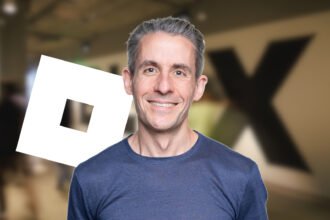 Roblox RDC 2026 - Nick Tornow with the Roblox logo against a blurry picture of the offices